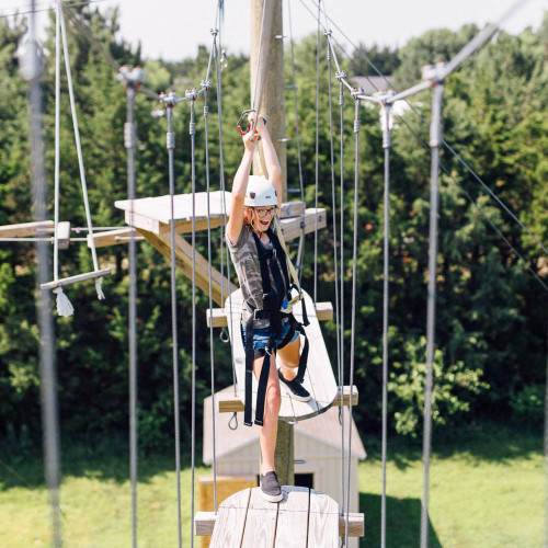 Child doing treetop adventure.