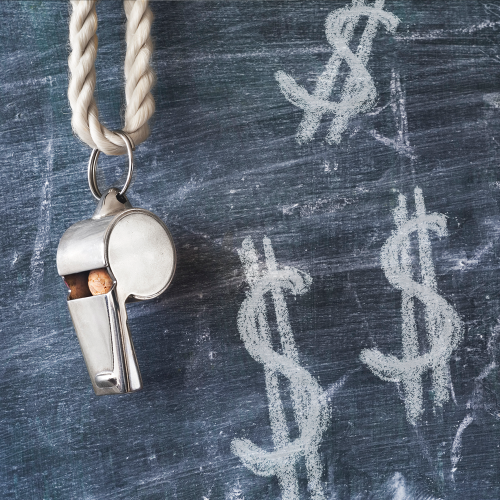 A whistle hanging against a chalkboard with dollar signs drawn on it