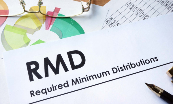 Glasses laying on a sheet of paper that says "RMD"