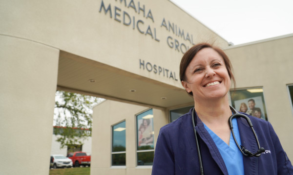Dr Courtney Knott stands in front of omaha animal medical group building